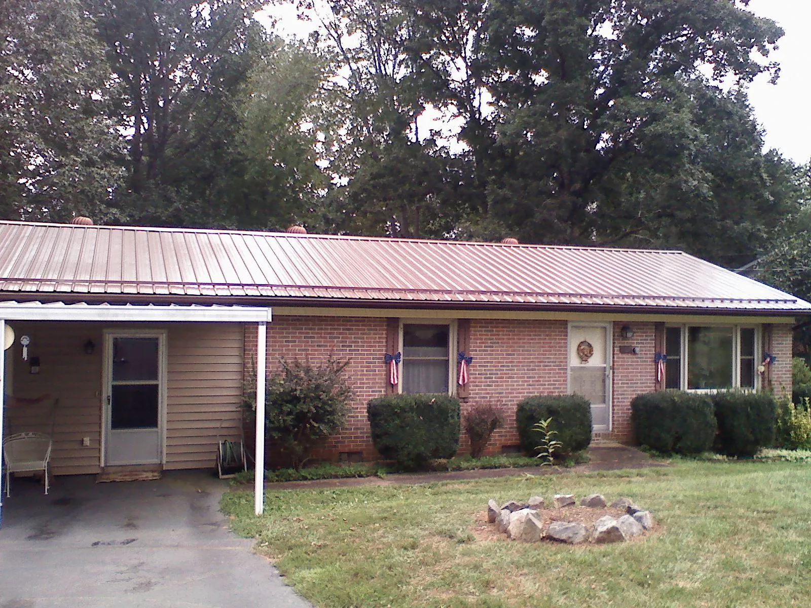 Bronze metal roof and carport on a brick ranch home — Roof Repair work by our crew in Breckenridge
